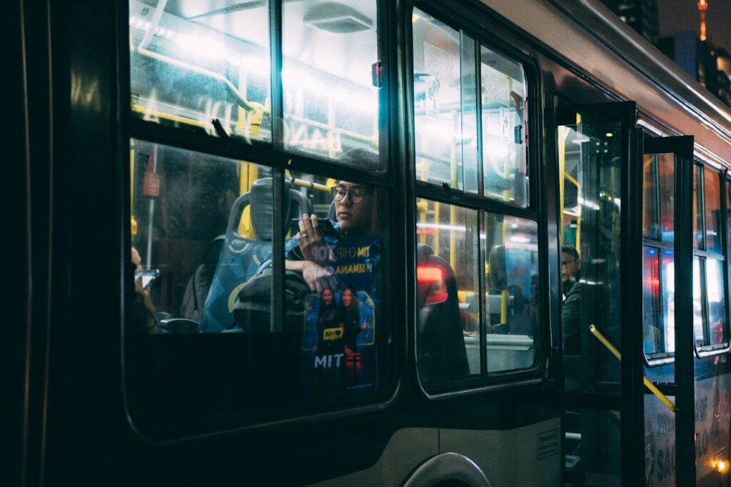 Passengers ride a city bus at night in São Paulo, capturing the essence of urban commuting.