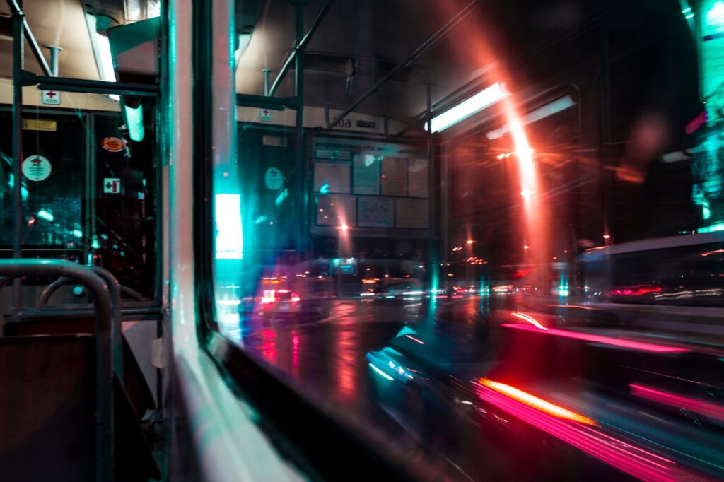 pexels-photo-974066 A vibrant urban scene depicting blurred night traffic seen through a bus window. Captures motion and city life.